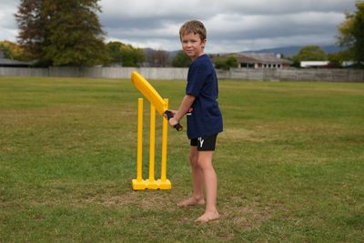 Child holding a cricket bat advertising Oscar subsidies being available