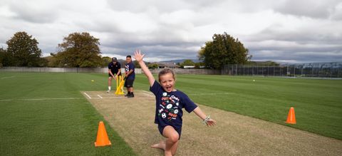 After school sports two children holding rugby balls